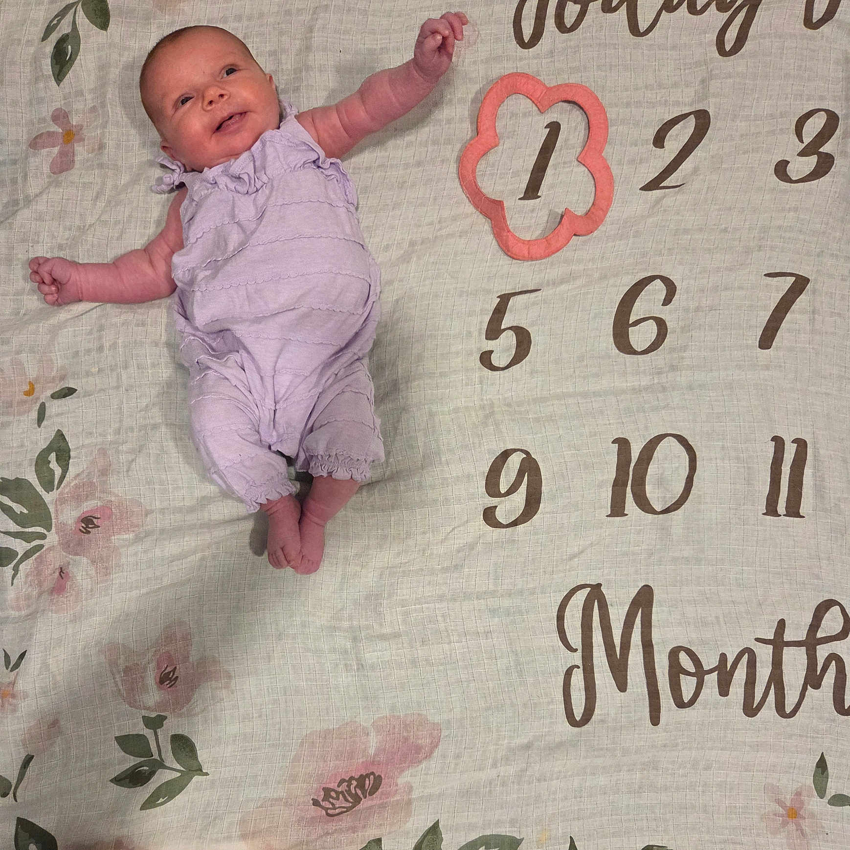Oakleigh joined the competition — help win amazing prizes! baby, infant, child, smiling, lying_down, portrait, milestone_blanket, one_month, floral, blanket, purple_outfit, onesie, barefoot, face, arms, legs, indoor, numbered_blanket, celebration, photography