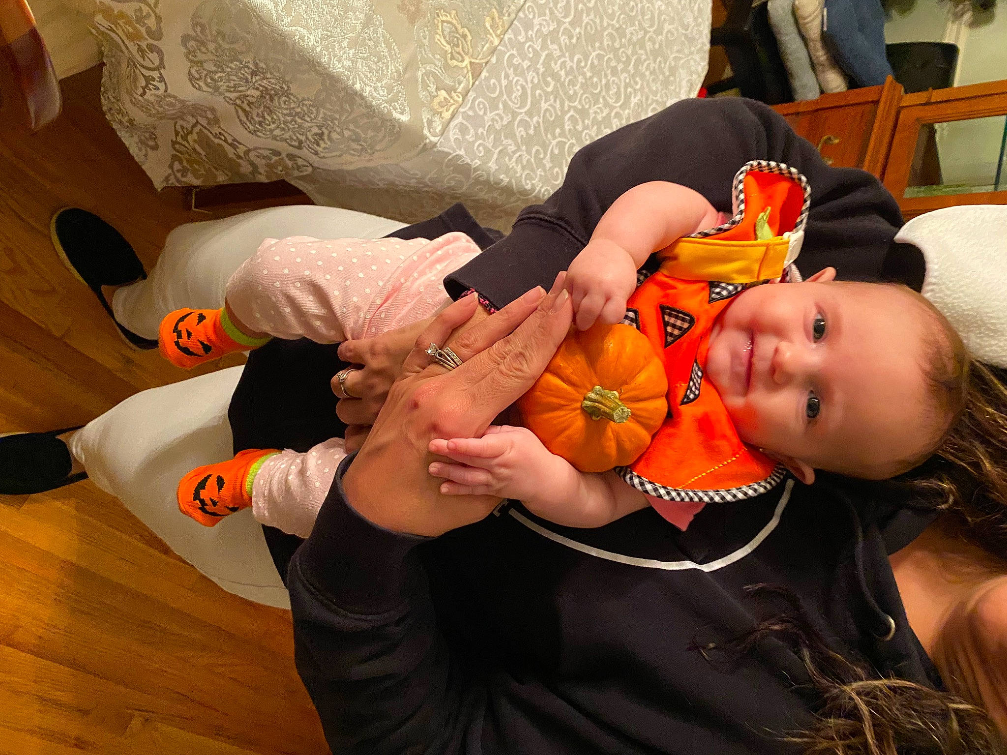 Hailey joined the competition — help win amazing prizes! baby, baby_products, chair, child, event, finger, fun, gesture, happy, hardwood, human_leg, joy, lap, nail, orange, person, room, sitting, sunglasses, toddler
