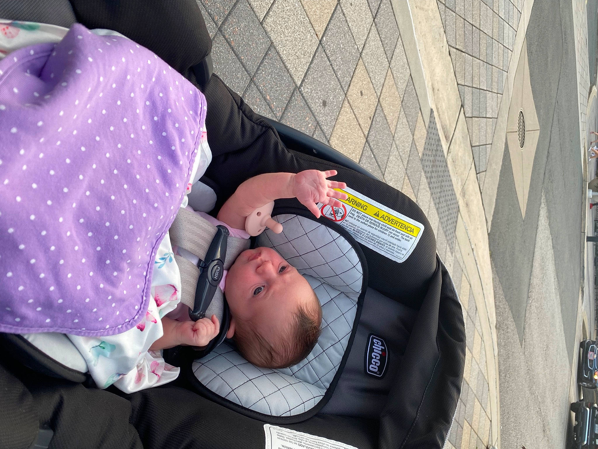 Hailey is registered to the contest to win money with this photo: baby, baby_carriage, baby_products, child, comfort, event, eyewear, hat, person, sitting, street, toddler