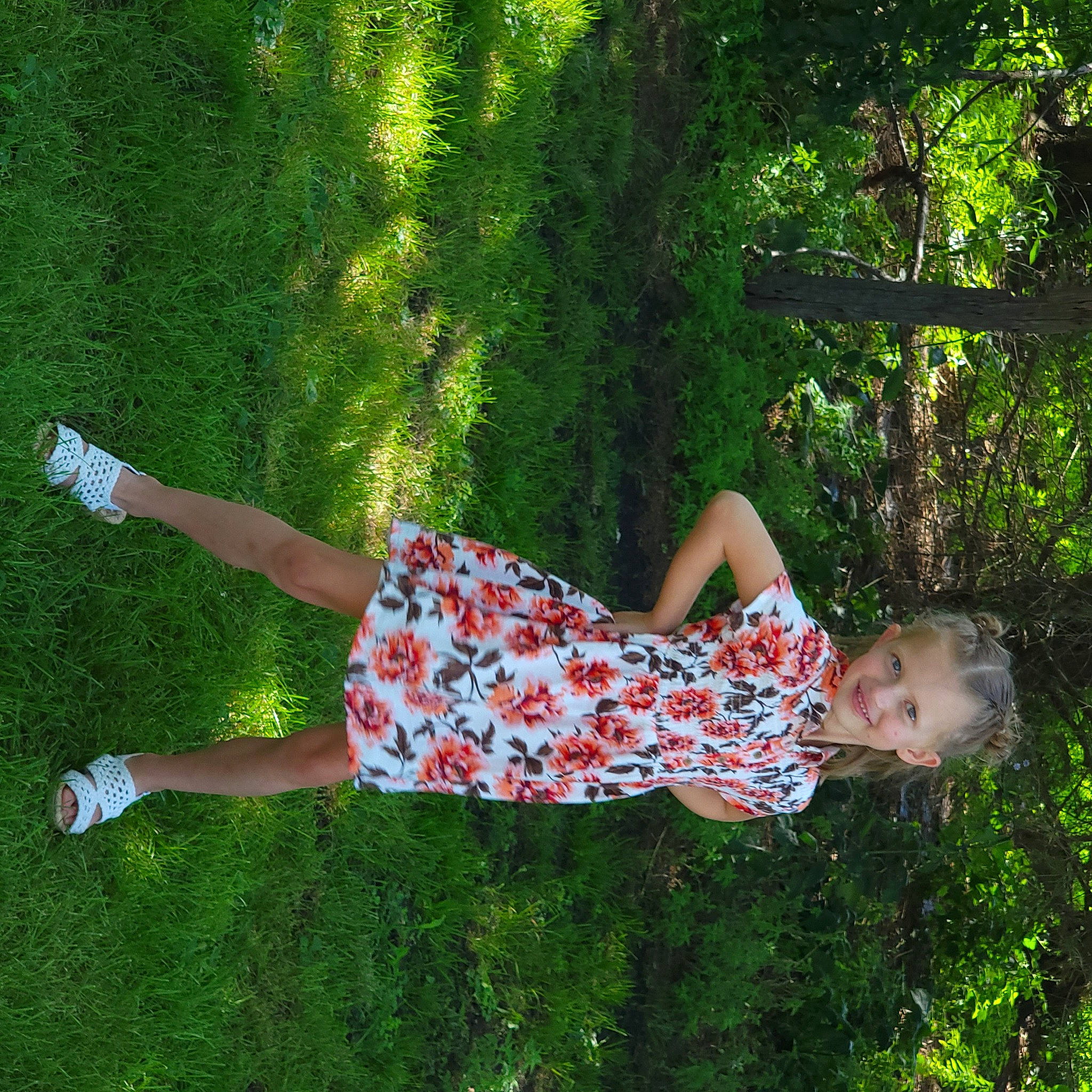 Grace is registered to the contest to win money with this photo: day_dress, dress, fun, grass, grass_family, happy, human_leg, joy, knee, leisure, meadow, pattern, people_in_nature, person, plant, shrub, summer, sunlight, thigh, tree