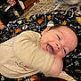 baby, smile, blanket, infant, happy, motion_blur, cozy, home, floor, carpet, furniture, child, cute, playful, warm, indoor, clothing, person, face, expression