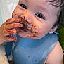 baby, blue_bib, child, chocolate, closeup, curly_hair, cute, eating, face, food, hands, happy, highchair, indoor, infant, messy, portrait, skin, smiling, toddler