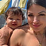 Jacobie is registered to the contest to win money with this photo: baby, blue_sky, child, clothespin, clothing, daylight, face, hair, hand, laundry, necklace, outdoor, person, portrait, shoulder, sky, smile, sunny, tattoo, woman
