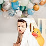 Jacobie is registered to the contest to win money with this photo: baby, child, towel, bunny_ears, rubber_duck, balloons, decor, curly_hair, cute, sitting, playful, studio, background, soft_texture, indoors, portrait, toy, yellow, white, celebration