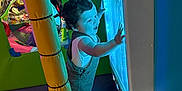 Jacobie joined the competition — help win amazing prizes! blue_light, child, colorful, curious, exploring, face, fun, happy, indoor_play_area, interactive, overalls, padded_floor, person, play, socks, soft, standing, toddler, yellow_pole, young_child