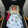 Atticus joined the competition — help win amazing prizes! baby, blanket, stroller, child, smile, infant, outdoor, rainy, black, golden, cozy, face, happy, person, clothing, fabric, transport, comfort, cute, portrait