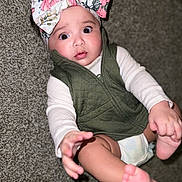 Kailani joined the competition — help win amazing prizes! ankle, baby, beanie, bodypart, bonnet, cap, clothing, diaper, face, finger, hand, hat, head, newborn, person, photography, portrait, sitting, sunhat, toe