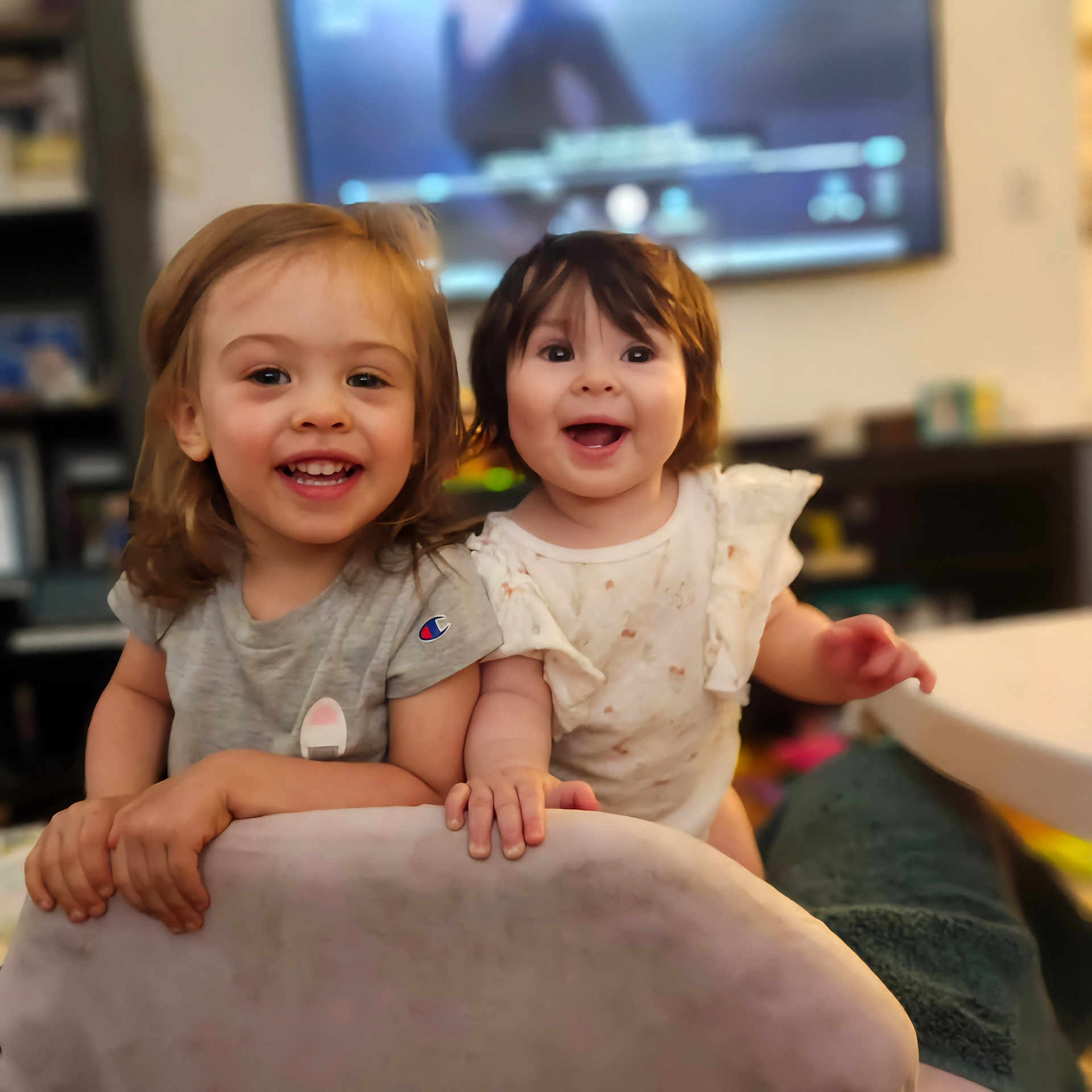 Zaylee And Mazie is registered to the contest to win money with this photo: architecture, baby, bodypart, building, computerhardware, couch, electronics, face, finger, furniture, hand, hardware, head, indoors, livingroom, monitor, person, room, screen, tv