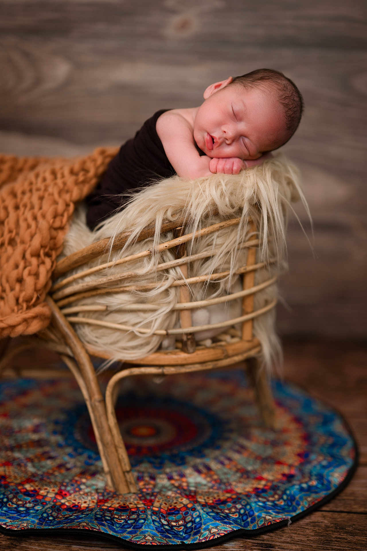 Axyl is registered to the contest to win money with this photo: newborn, baby, sleeping, wicker_chair, blanket, fluffy_cushion, wooden_floor, colorful_rug, portrait, cozy, infant, resting, indoor, soft_lighting, peaceful, cute, child, warm_colors, texture, decor