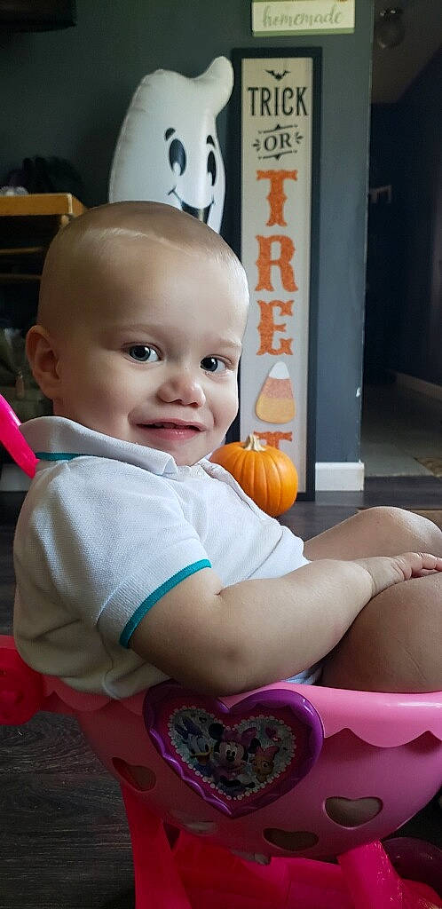 Kashtyn is registered to the contest to win money with this photo: baby, baby_products, baby_toddler_clothing, calabaza, cheek, child, facial_expression, flooring, fun, happy, human_leg, joy, person, plant, pumpkin, room, sitting, smile, toddler, vegetable