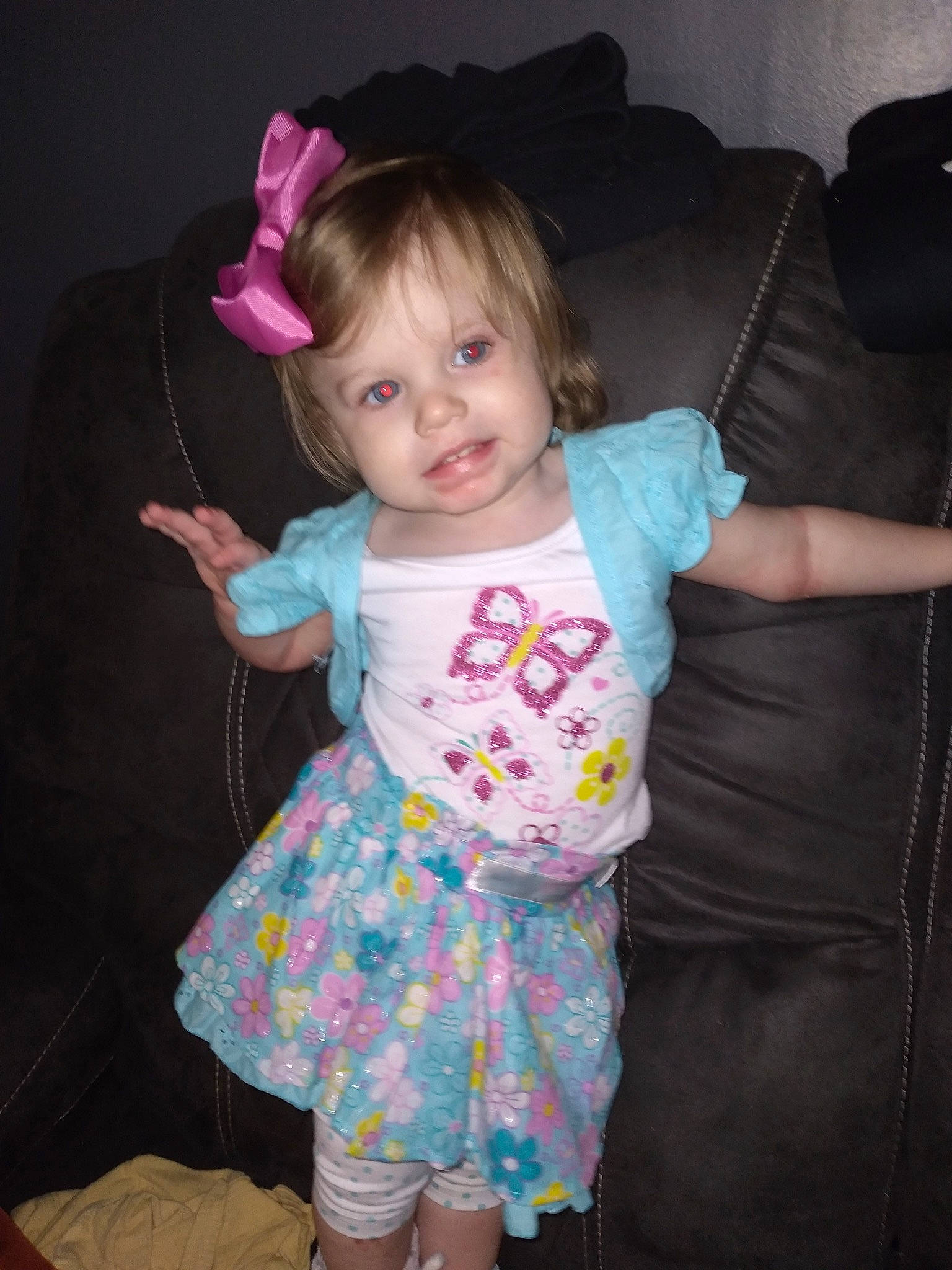 Kelahni is registered to the contest to win money with this photo: arm, baby_toddler_clothing, cheek, child, clothing, dress, finger, fun, gesture, hand, happy, leg, magenta, pattern, person, pink, skin, sleeve, textile, thumb