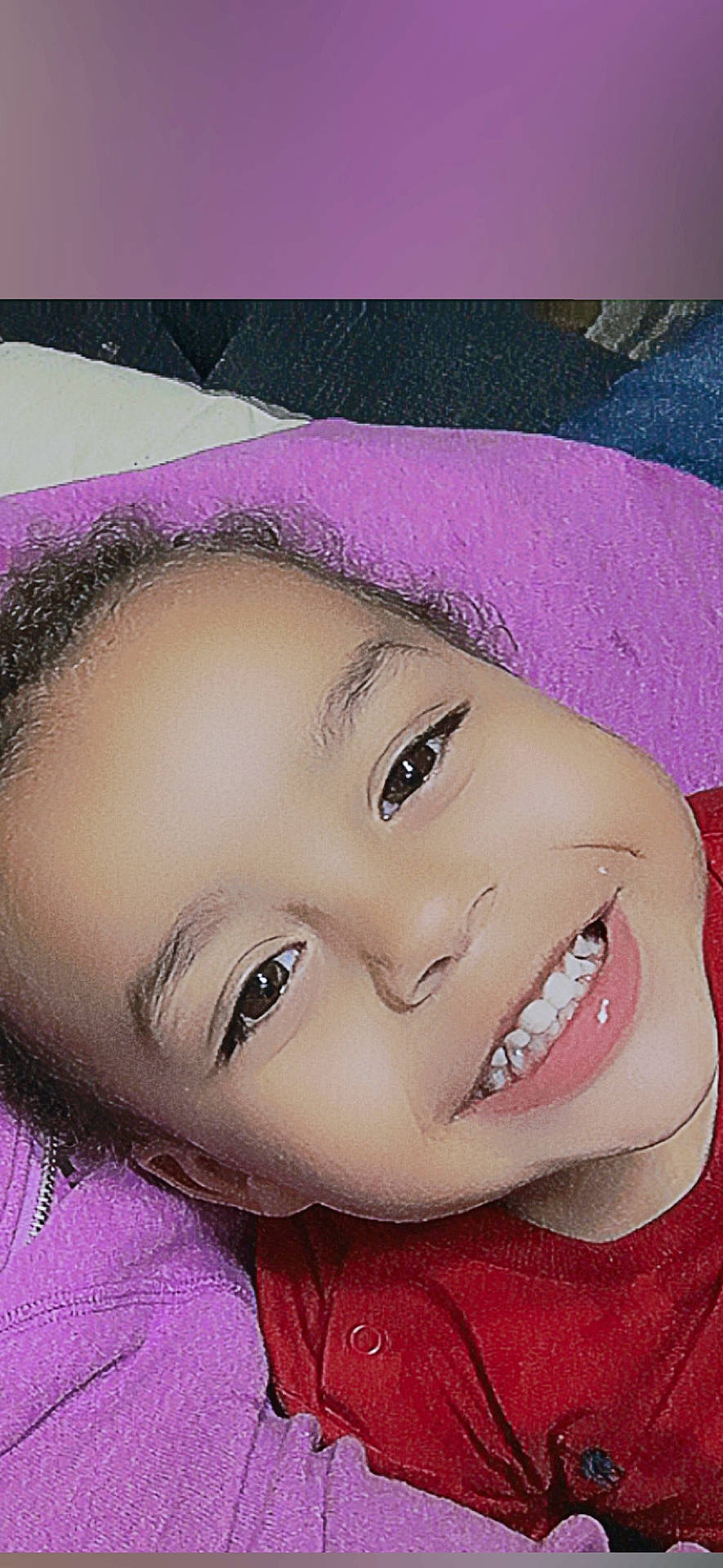 Kashtyn is registered to the contest to win money with this photo: blanket, child, closeup, cozy, cute, expression, eyes, face, happy, head, indoors, joyful, person, portrait, purple, red_shirt, skin, smile, warmth, young