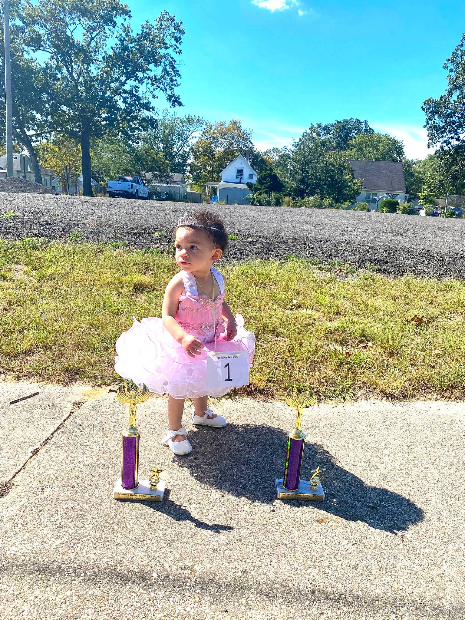 Mailani is registered to the contest to win money with this photo: asphalt, cloud, dress, event, footwear, fun, grass, grass_family, grassland, happy, landscape, lawn, leisure, natural_environment, people_in_nature, person, plant, recreation, sky, toddler