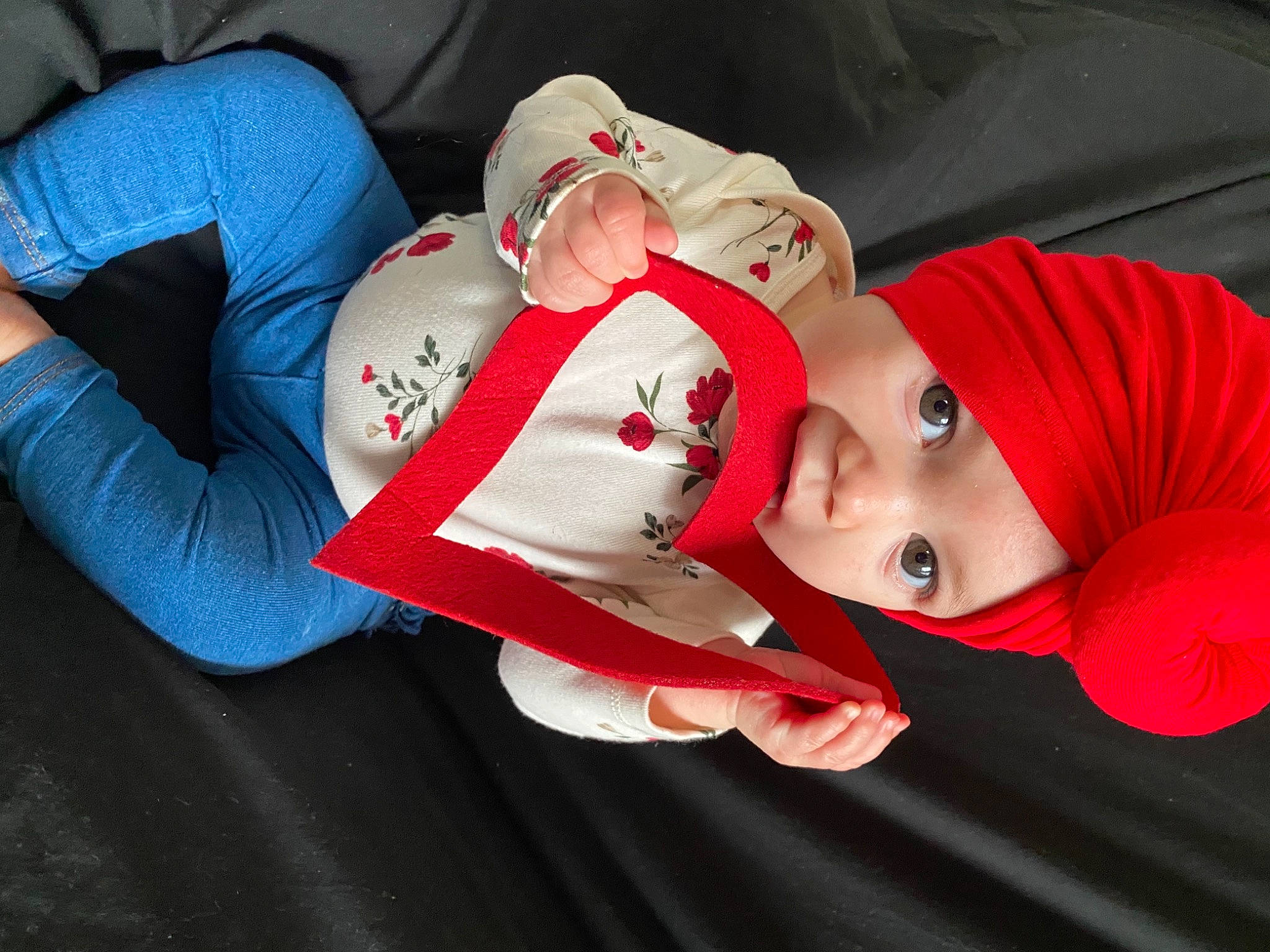 Mailani is registered to the contest to win money with this photo: baby, baby_toddler_clothing, carmine, cheek, child, comfort, elbow, eye, happy, hat, headwear, human_leg, lip, outerwear, person, red, skin, sleeve, textile, thigh