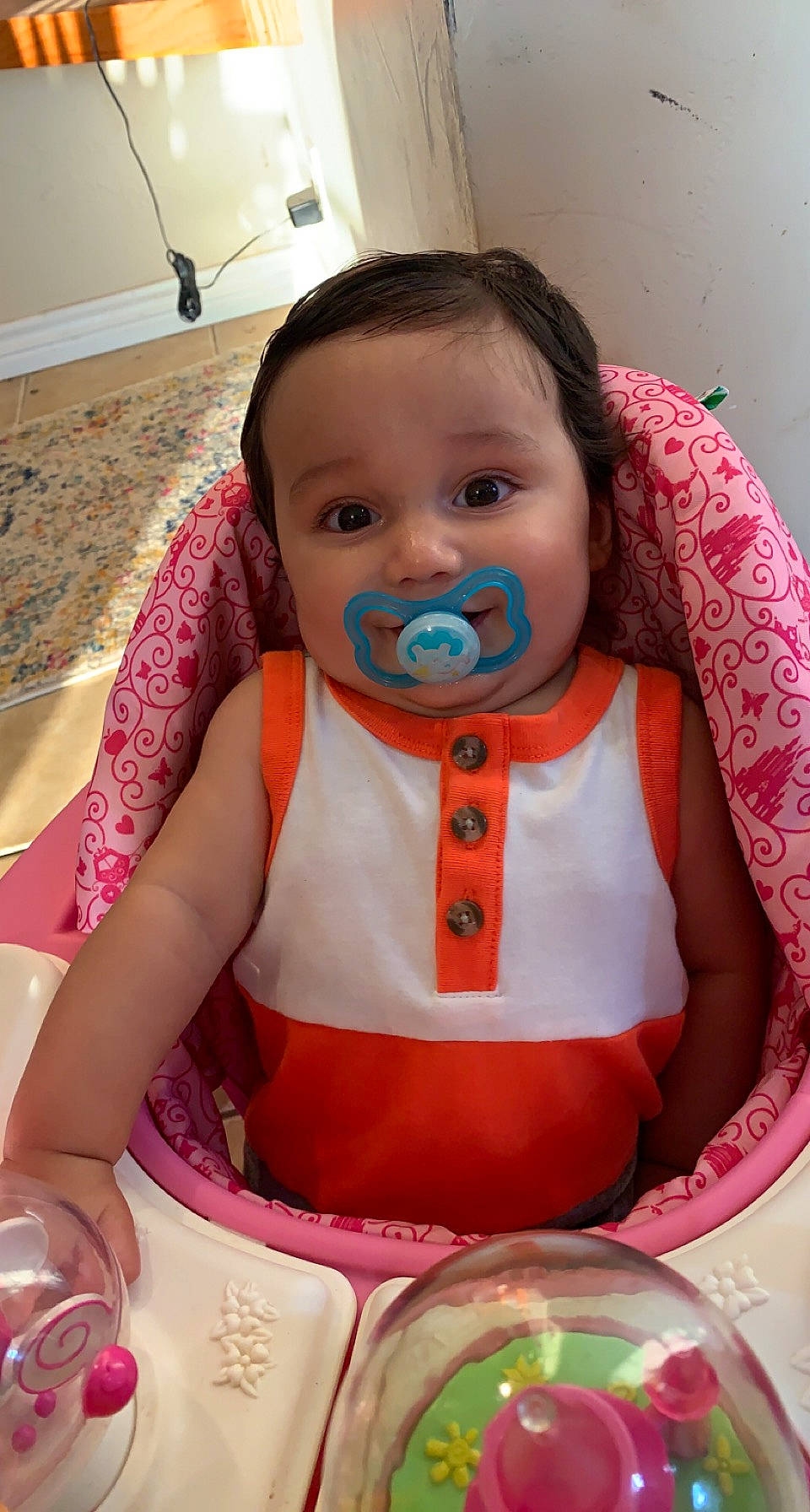 Keelan is registered to the contest to win money with this photo: baby, baby_products, baby_toddler_clothing, bib, cheek, child, dress, drinkware, event, face, facial_expression, happy, head, mouth, person, pink, serveware, sitting, skin, tableware