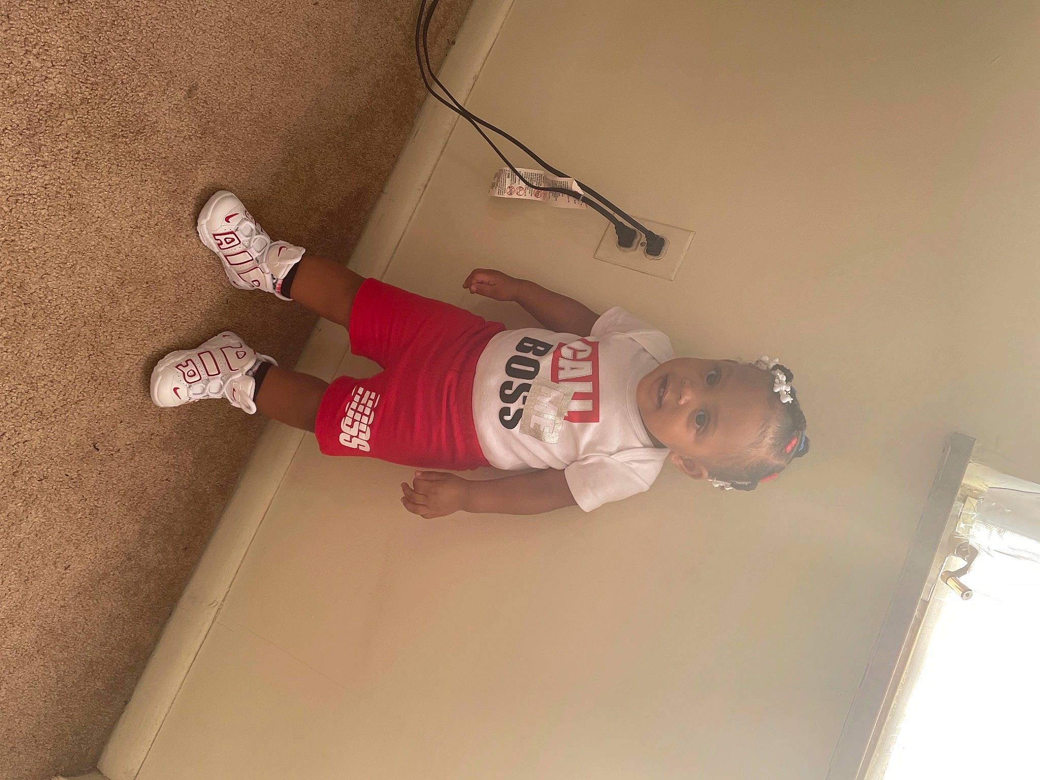 Nevaeh is registered to the contest to win money with this photo: beer, carmine, elbow, flooring, hardwood, human_leg, knee, packing_materials, person, plaster, room, shorts, smile, sock, t_shirt, thigh, wood, wrist