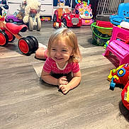 Barbie Rae joined the competition — help win amazing prizes! child, toddler, smiling, portrait, indoors, playroom, toys, toy_cars, stuffed_animal, ride_on_toy, tricycle, pink_shirt, sitting, floor, wood_floor, playpen, toy_chair, colorful, happy, 家庭