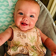 éabha joined the competition — help win amazing prizes! animal_print, arm, baby, baby_dress, blue_eyes, child, closeup, cute, face, happy, head, high_chair, indoor, infant, patterned_clothing, pink_pacifier, seat, seatbelt, skin, smiling