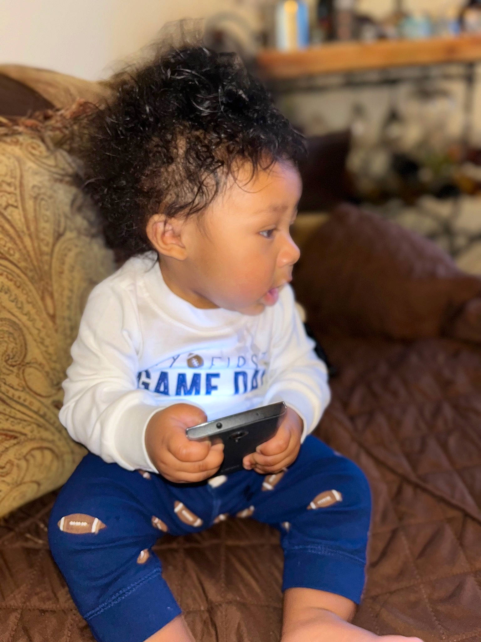 Donavon is registered to the contest to win money with this photo: baby, baby_toddler_clothing, cheek, child, comfort, couch, elbow, electric_blue, fun, hand, happy, human_leg, leisure, person, sitting, skin, sleeve, t_shirt, thigh, toddler