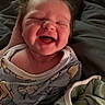 baby, infant, smiling, laughing, pajamas, blanket, cozy, indoors, cute, child, face, happy, newborn, person, sleepwear, soft_light, portrait, hand, comfort, warm