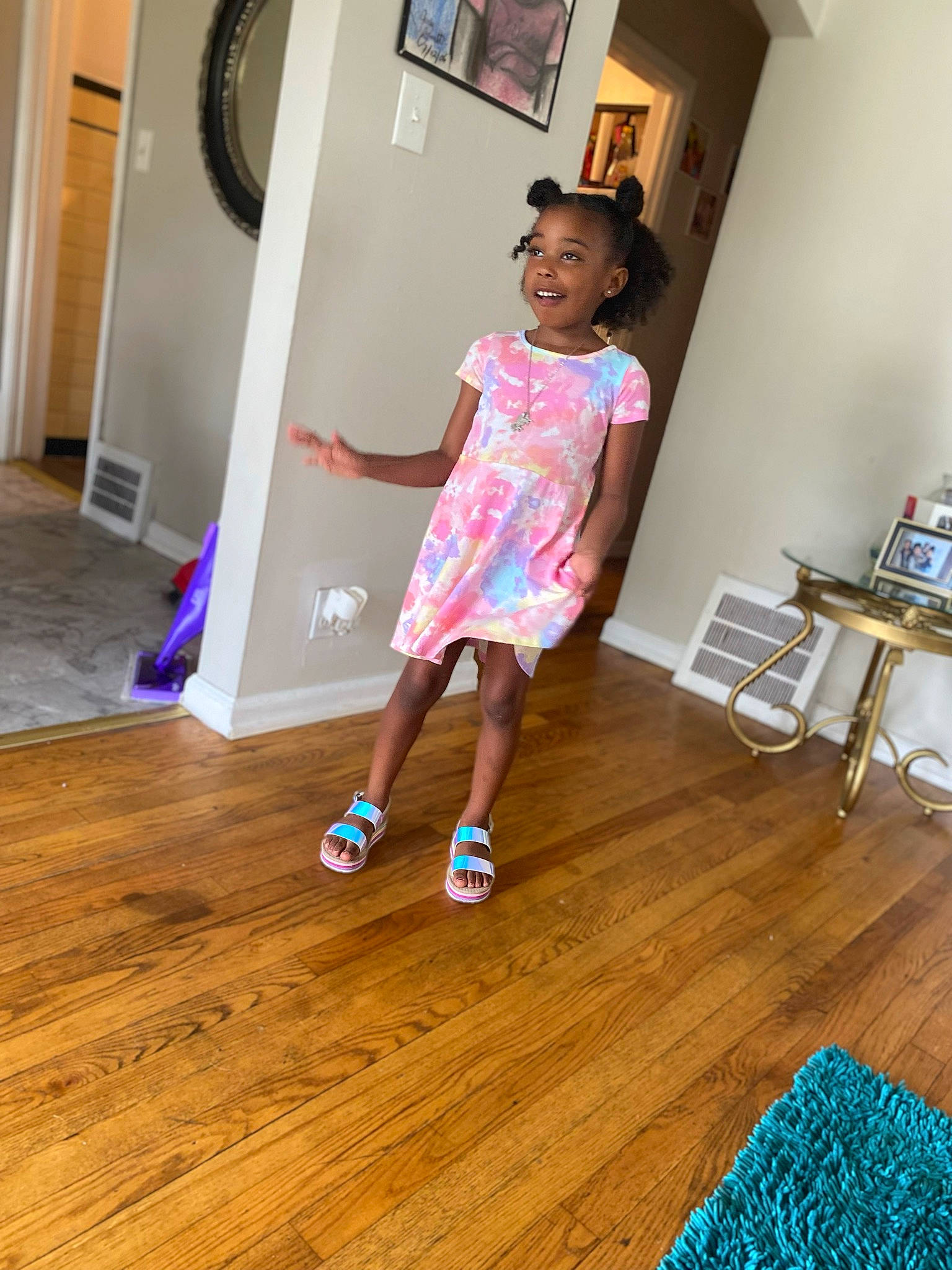 Naria is registered to the contest to win money with this photo: child, door, floor, flooring, hardwood, house, human_leg, joy, laminate_flooring, leisure, magenta, person, purple, room, shorts, smile, t_shirt, toddler, varnish, wood