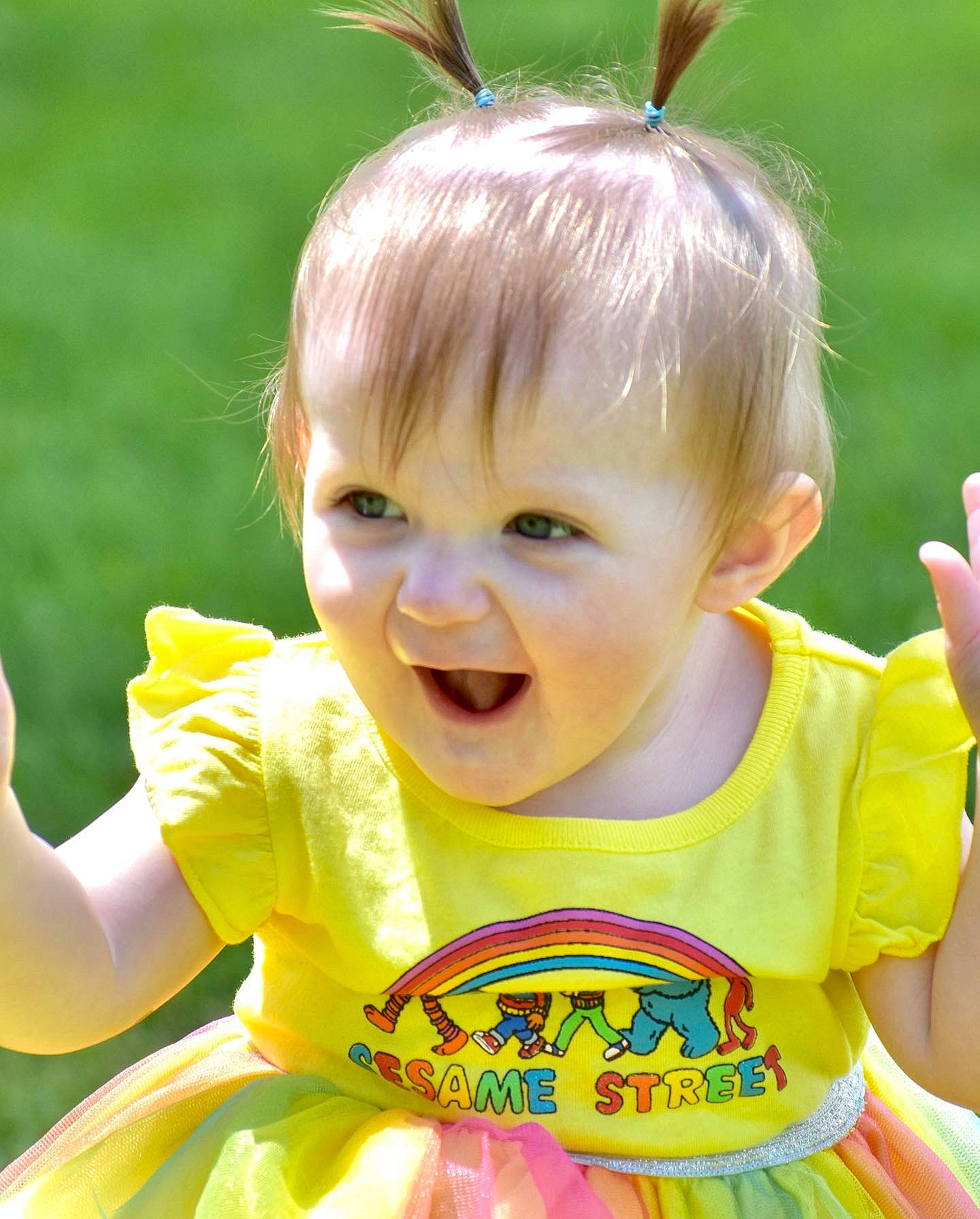 Freya is registered to the contest to win money with this photo: baby, baby_toddler_clothing, child, face, facial_expression, fun, grass, green, happy, iris, people, people_in_nature, person, pink, product, skin, sleeve, smile, summer, toddler