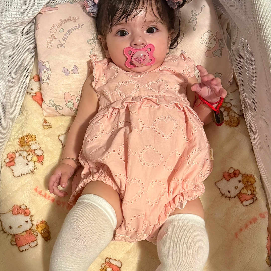 Camila joined the competition — help win amazing prizes! baby, baby_bed, blanket, bracelet, child, comfort, cute, girl, hello_kitty, indoor, infant, pacifier, pigtails, pillow, pink_outfit, portrait, sleeping_area, soft_lighting, toy, white_socks