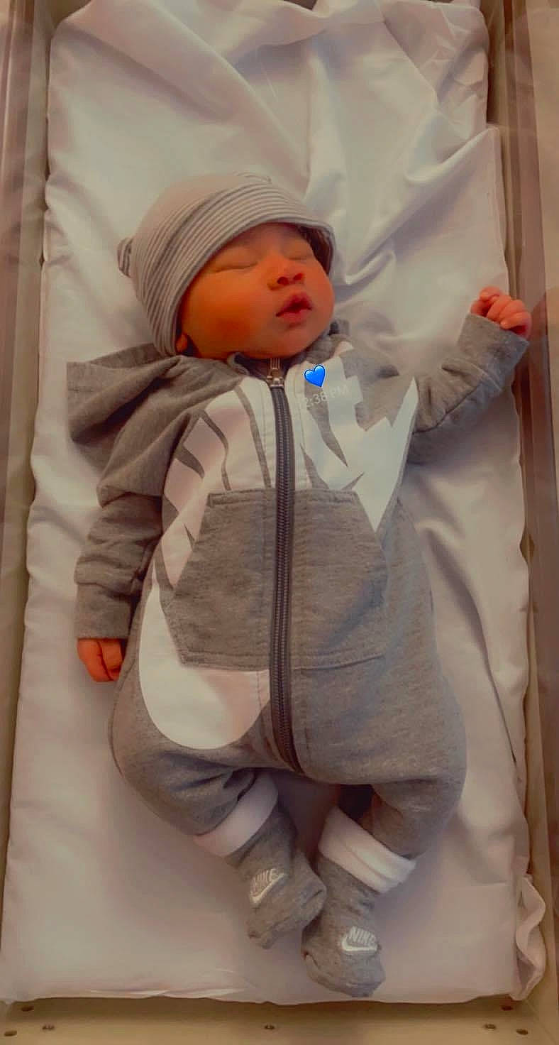 Cory is registered to the contest to win money with this photo: baby, baby_products, baby_safety, baby_sleeping, baby_toddler_clothing, cheek, child, collar, comfort, face, headwear, linens, person, room, skin, sleeve, thumb, toddler