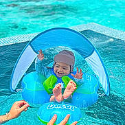 Cyrus joined the competition — help win amazing prizes! baby, pool, water, inflatable, float, sunshade, swimming, child, smiling, hands, blue, summer, outdoor, safety, playful, cute, fun, feet, hat, lifejacket