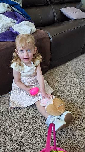 Izabella joined the competition — help win amazing prizes! baby, baby_toddler_clothing, child, comfort, couch, floor, flooring, fun, hairstyle, happy, human_leg, lap, leg, leisure, person, pink, sitting, smile, thigh, toddler