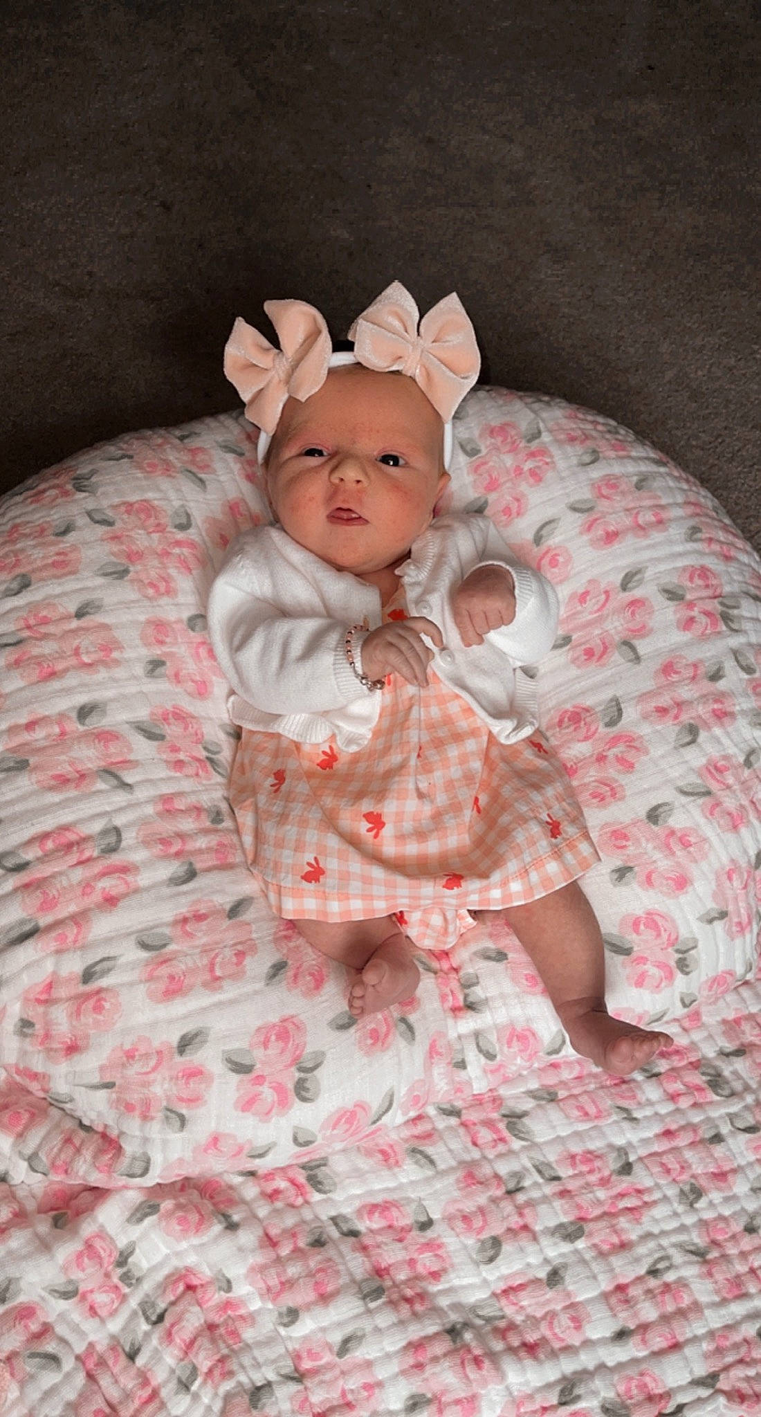 Sadie is registered to the contest to win money with this photo: baby, baby_toddler_clothing, cap, child, comfort, costume_hat, eye, fashion_accessory, head, headband, headpiece, iris, linens, mammal, pattern, peach, person, pink, sleeve, textile