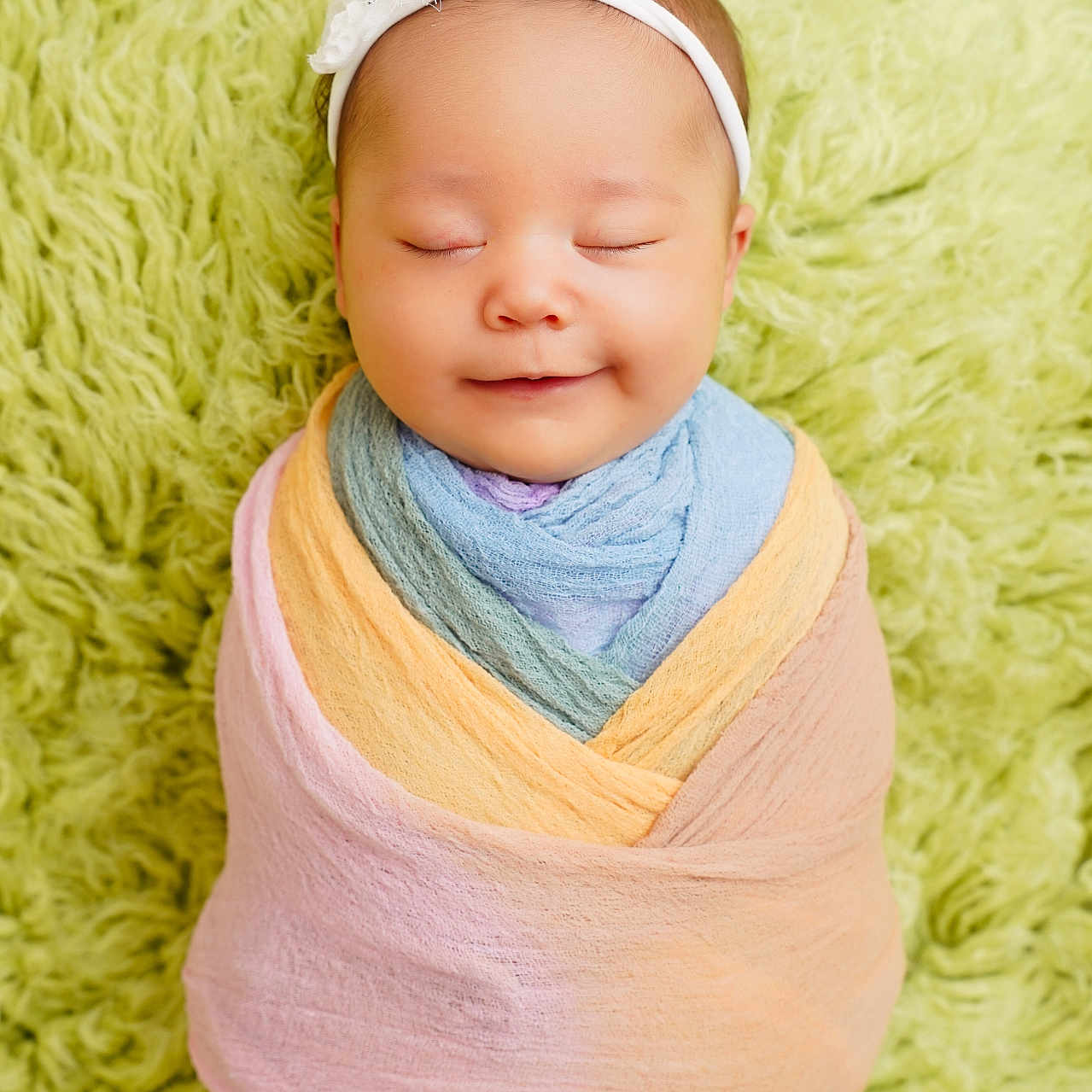 Nathalie is registered to the contest to win money with this photo: baby, blanket, child, closeup, cozy, cute, headband, indoors, infant, newborn, pastel_colors, peaceful, portrait, resting, sleeping, smiling, soft_texture, swaddle, toddler, wrapped