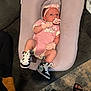 baby, baby_lounger, black_and_white_shoes, carpet, couch, cute, feet, floor, headband, home_interior, indoor, infant, mittens, pacifier, person, pink_onesie, relaxing, sandals, sneakers, socks