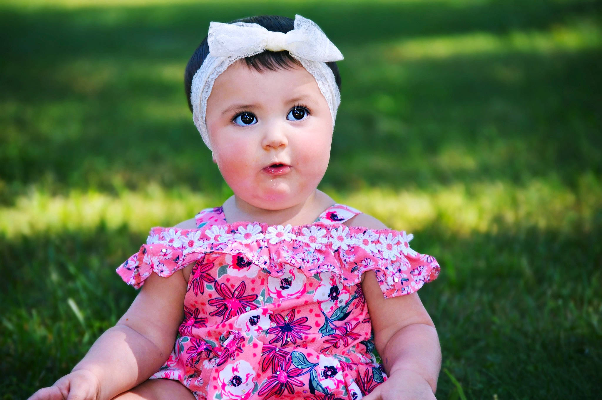 Oaklei is registered to the contest to win money with this photo: baby, baby_products, baby_toddler_clothing, cheek, child, dress, eye, grass, hair_accessory, head, headgear, headwear, lip, pattern, person, photography, pink, plant, skin, spring