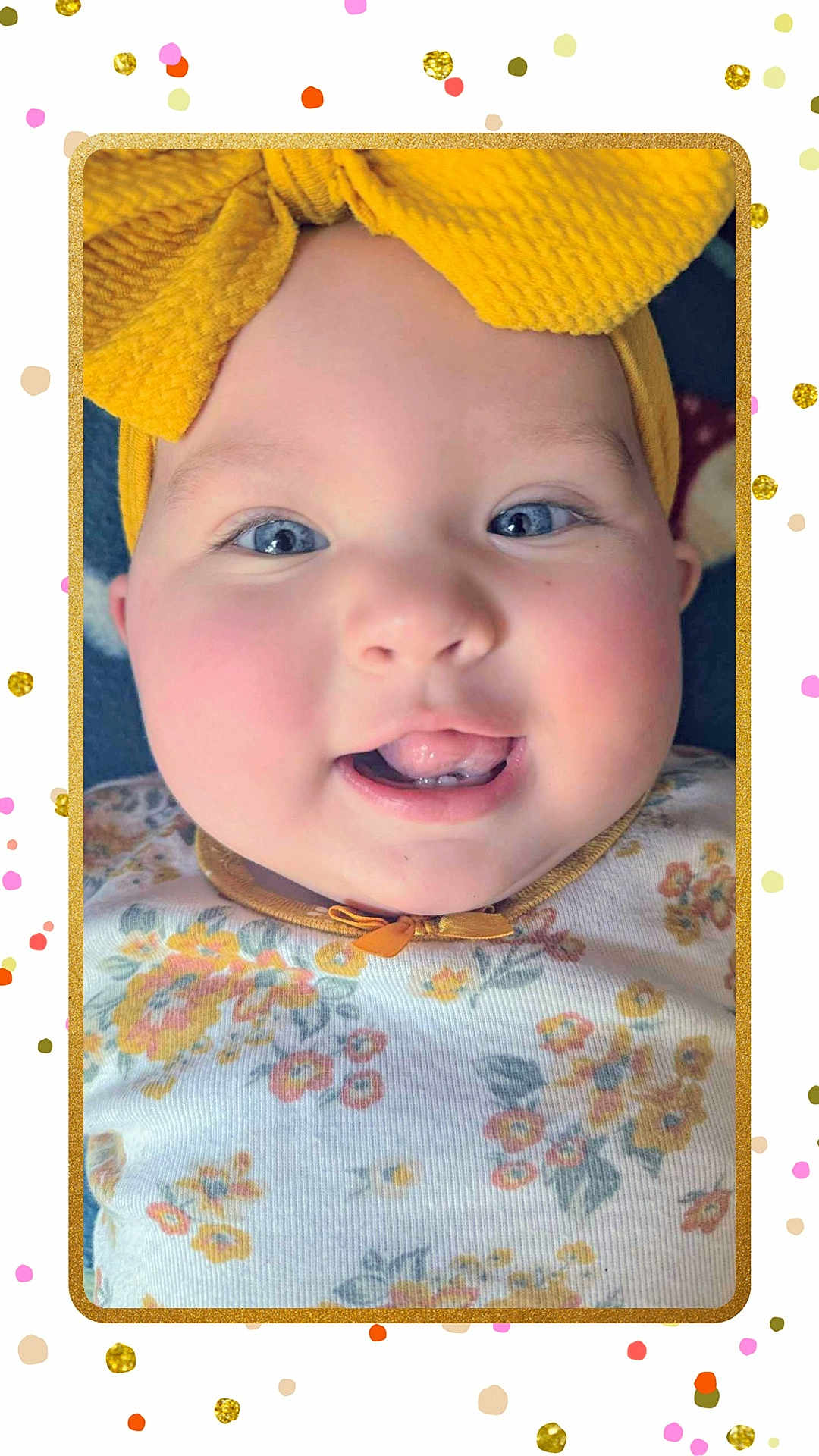 Lilianne joined the competition — help win amazing prizes! baby, child, face, headband, yellow_bow, blue_eyes, smile, tongue, teeth, floral_clothing, cheeks, closeup, portrait, cute, infant, pink_cheeks, confetti, frame, happy, indoors