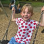 Siana participe au concours pour gagner de l'argent avec cette photo : child, swing, playground, smiling, happy, outdoor, summer, shorts, tshirt, apple_print, chain, seat, play, fun, person, casual_clothing, park, daylight, blond_hair, grass