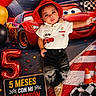 Noah Sotolongo joined the competition — help win amazing prizes! baby, child, red_hat, racing_theme, race_car, balloons, number_5_balloon, sign, checkered_flag, traffic_cone, black_pants, white_shirt, shoes, celebration, stadium, confetti, portrait, indoor, colorful, smiling