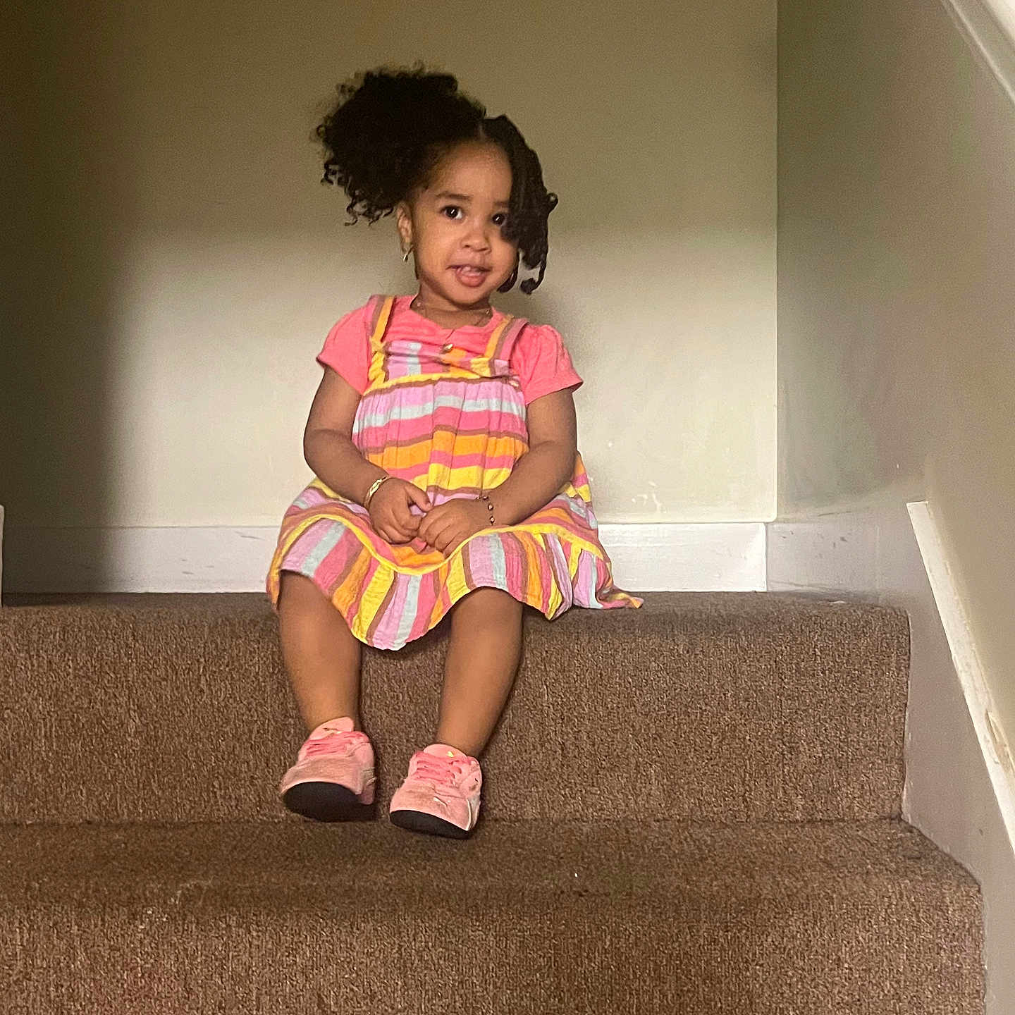 Analina is registered to the contest to win money with this photo: accessories, carpet, casual, child, curly_hair, cute, dress, fashion, girl, happy, indoor, person, pink_shoes, playful, portrait, sitting, smiling, stairs, toddler, young_child