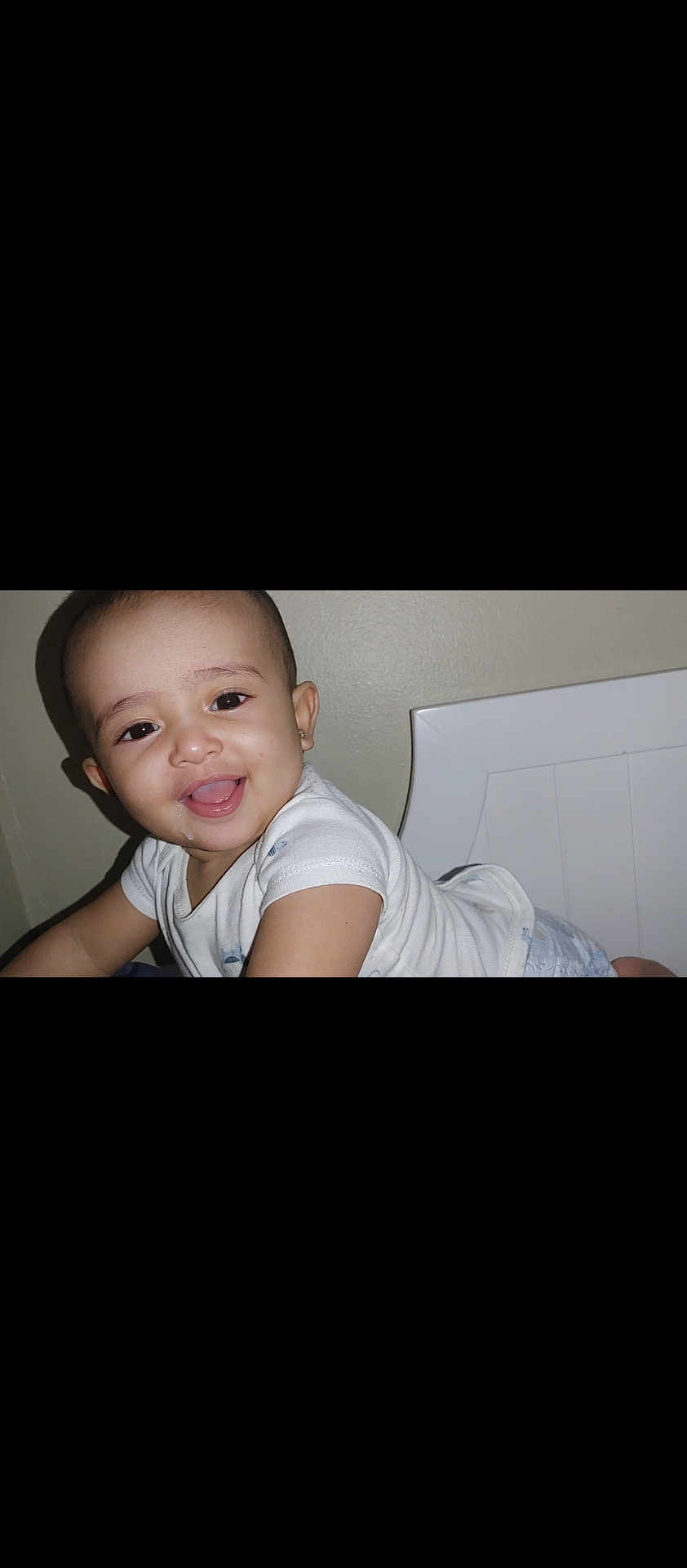 Jana joined the competition — help win amazing prizes! baby, child, smiling, crawling, white_clothing, earring, indoor, wall, furniture, happy, face, portrait, skin, head, person, toddler, cute, infant, young_child, expression