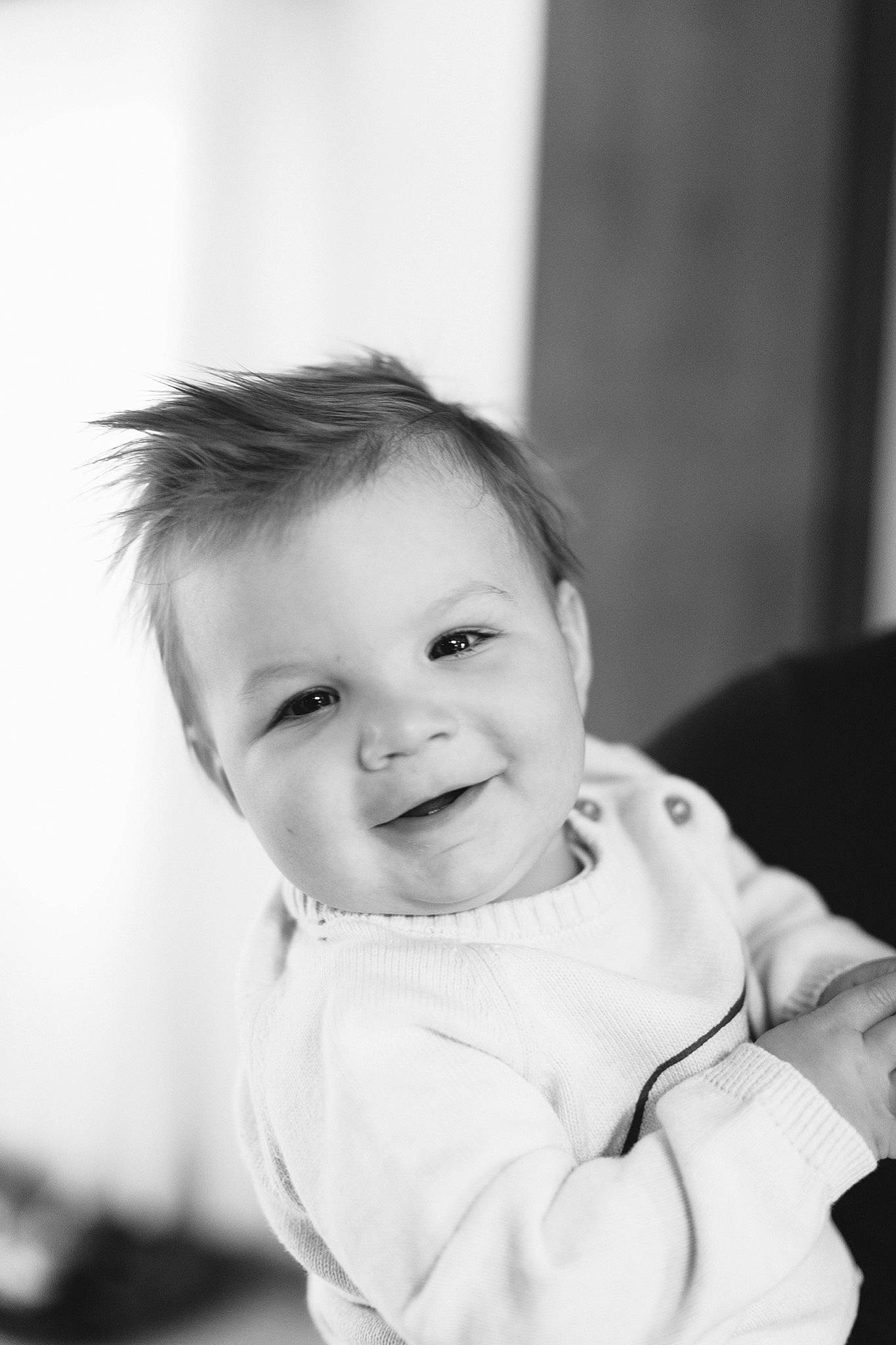Simon is registered to the contest to win money with this photo: baby, baby_toddler_clothing, black_and_white, cheek, child, chin, eyebrow, eyelash, face, flash_photography, fun, happy, iris, joy, monochrome, monochrome_photography, person, sitting, sleeve, smile