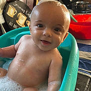 Asher is registered to the contest to win money with this photo: baby, bath, bubbles, smile, water, tub, kitchen, utensils, foam, child, happy, wet, cute, indoor, face, skin, head, arm, sitting, playful