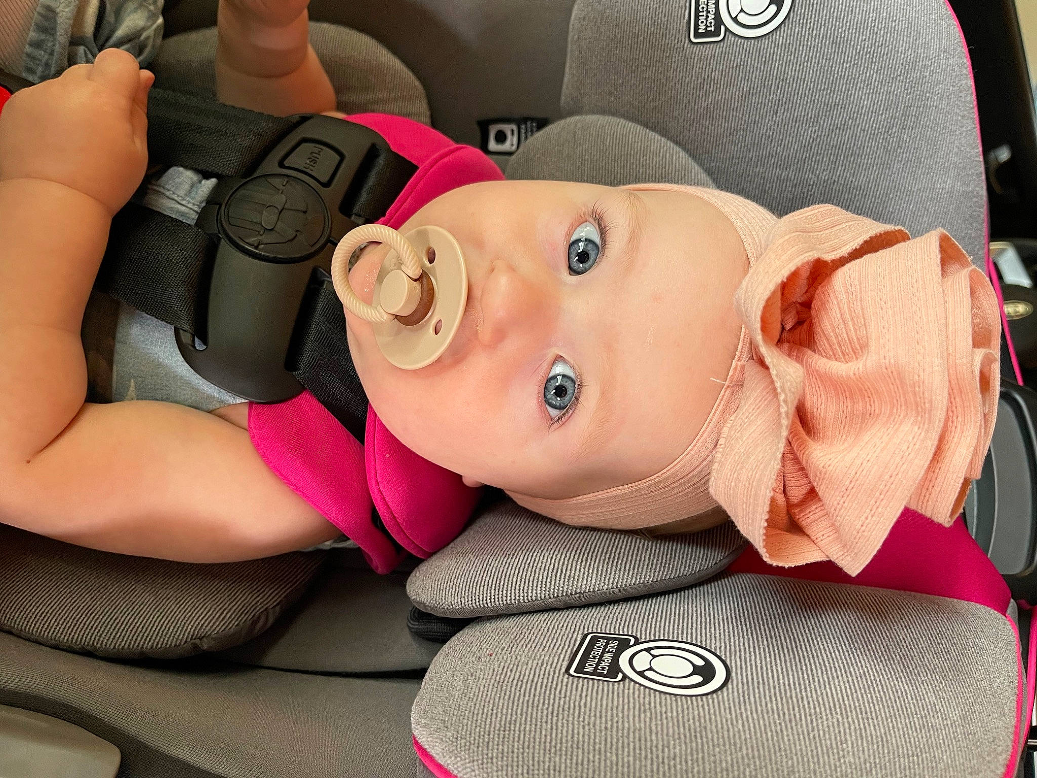 Georgia is registered to the contest to win money with this photo: auto_part, automotive_design, baby_carriage, baby_products, car, car_seat, car_seat_cover, child, comfort, family_car, fun, head_restraint, headwear, motor_vehicle, mouth, person, pink, product, steering_wheel, toddler