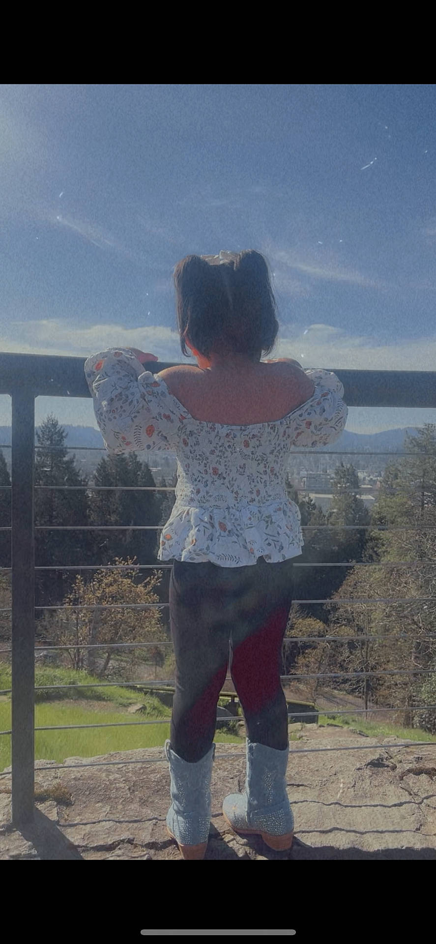 Kamilah joined the competition — help win amazing prizes! back_view, blue_sky, boots, child, clothing, daylight, fence, floral_top, landscape, leggings, mountains, nature, outdoor, pigtails, rock, scenery, sky, standing, trees, view