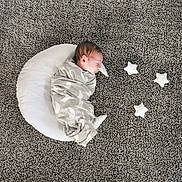 Domenic joined the competition — help win amazing prizes! newborn, baby, swaddled, blanket, crescent_pillow, stars, soft_toys, carpet, gray, sleeping, peaceful, cozy, infant, resting, indoors, child, portrait, cute, decor, nursery