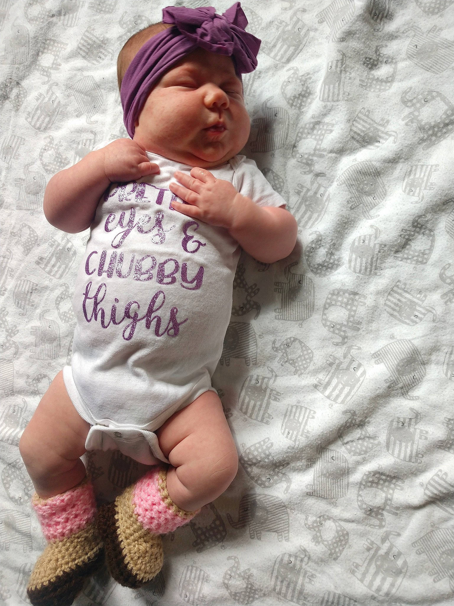 Cora-jane is registered to the contest to win money with this photo: baby, baby_toddler_clothing, child, fawn, headgear, headwear, pattern, person, pink, purple, skin, smile, toddler