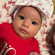 Alaiyah is registered to the contest to win money with this photo: baby, background_blur, bow, child, close_up, cute, expression, eyes, face, hand, headband, indoors, infant, newborn, person, polka_dots, portrait, red_clothing, skin, soft_focus