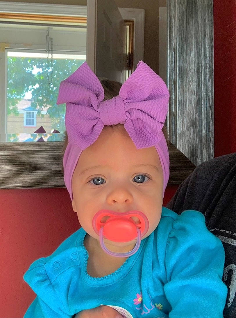 Kyler is registered to the contest to win money with this photo: baby, baby_toddler_clothing, cap, cheek, child, costume_hat, electric_blue, eye, fashion_accessory, fun, happy, hat, headgear, headwear, human_body, magenta, party_supply, person, pink, purple