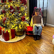 Dashley joined the competition — help win amazing prizes! child, smiling, toy_car, christmas_tree, ornaments, presents, holiday, indoors, wooden_floor, curtains, lamp, decorations, festive, girl, ribbons, boots, jeans, sweater, lighting, playful