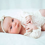 Bobbi-J joined the competition — help win amazing prizes! baby, infant, newborn, lace, headband, flower, white, soft, bed, cute, portrait, child, skin, face, hand, lying_down, peaceful, young, closeup, indoors
