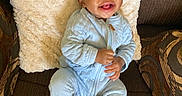 Alexander joined the competition — help win amazing prizes! baby, smiling, blue_onesie, socks, couch, pillow, happy, infant, seated, indoor, child, portrait, cute, young, cozy, home, person, furniture, comfort, expression